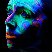 Girl looking away - painted face bright colors.